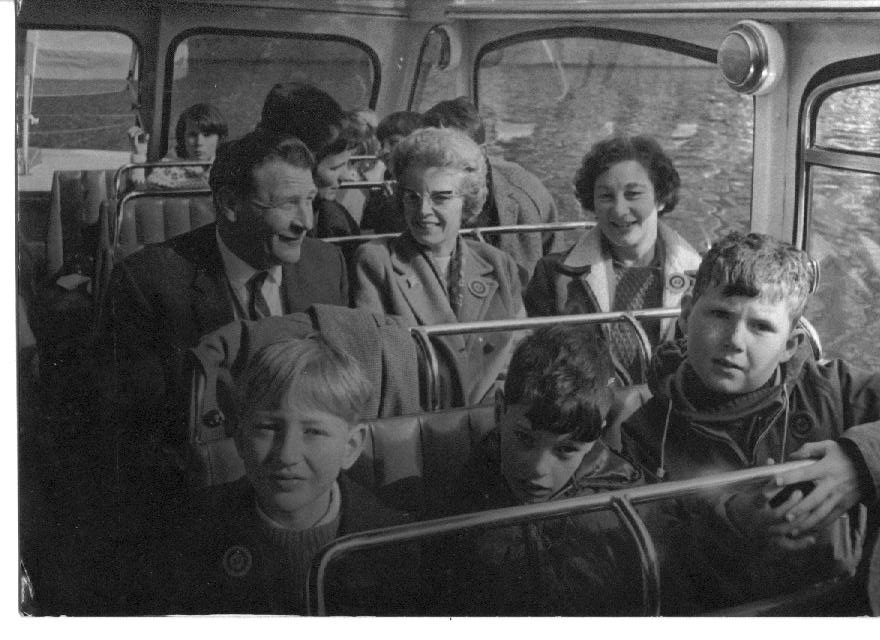 Adults and children on a school bus trip c1965