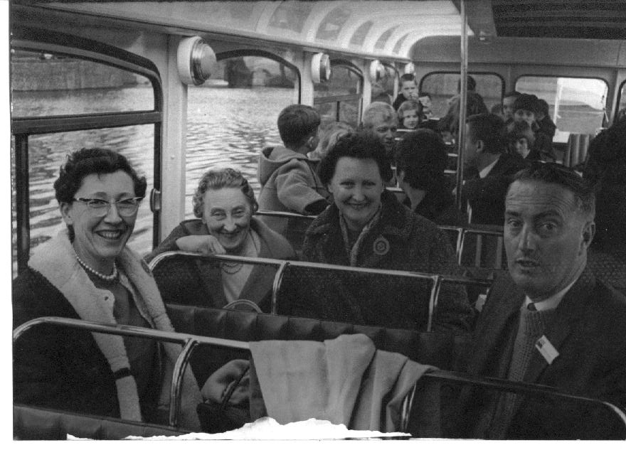 Adults and children on a school bus trip c1965