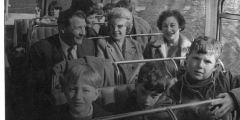 Adults and children on a school bus trip c1965