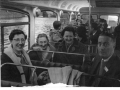 Adults and children on a school bus trip c1965