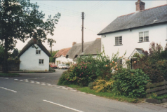 AAPC-6-1-005 -- Dunkirt Lane and Monxton Rd entrance to Dunkirt Lane from the Monxton Rd. The cars are parked outside The Old Bakery.  No 49 and Jubilee Oak Cottage in foreground