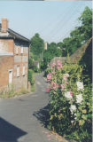 AAPC-6-1-011 -- Monxton Road (West Hill) looking east, Lower Cottage, church tower in background -- 12-Jul-1999