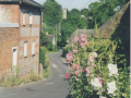 AAPC-6-1-011 -- Monxton Road (West Hill) looking east, Lower Cottage, church tower in background -- 12-Jul-1999